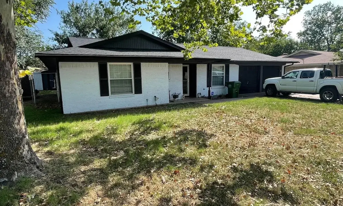 Professional roofing crew working on a residential roof in Navasota